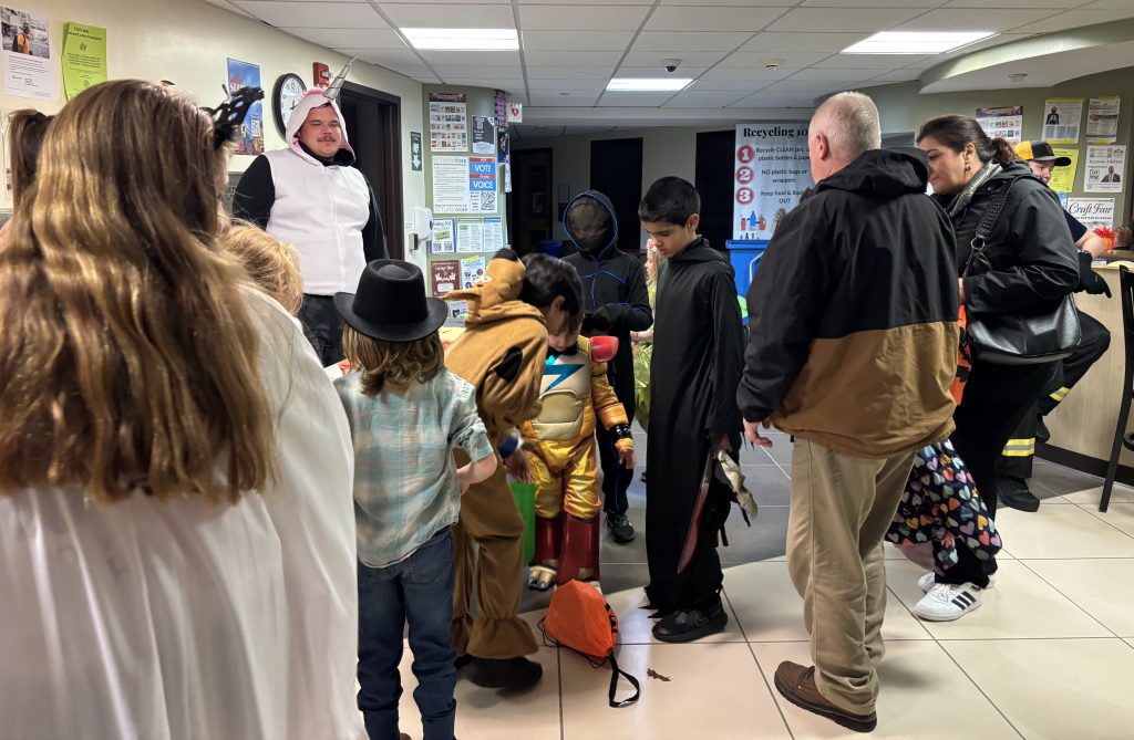Families gathering in the lobby of the Wilber Hall dormitory during the 2025 Halloween in the Halls event at SUNY Oneonta. (Photo by Jaquelyn Carlo)