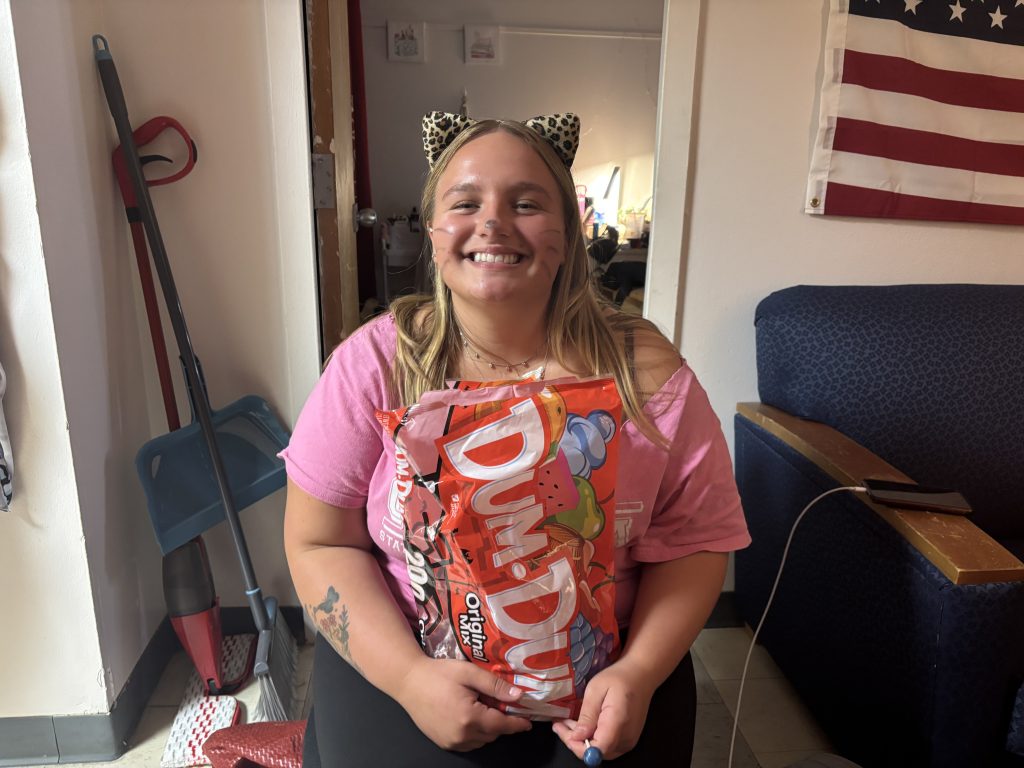 Sophia Svec, a sophomore at SUNY Oneonta, prepares to hand out candy from her dorm room during Halloween in the Halls. (Photo by Jaquelyn Carlo)