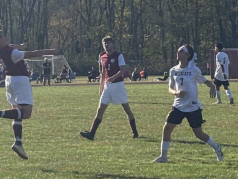 Three people playing soccer.