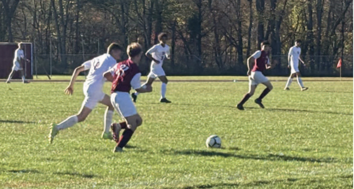 Soccer player going to get a touch on the ball.