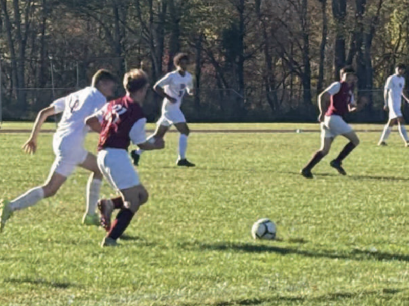 Soccer player going to get a touch on the ball.