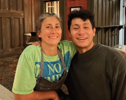 Two people standing together posing for a photo. 