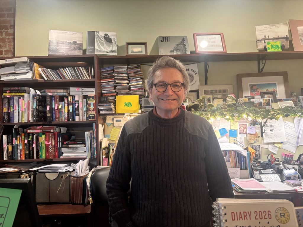 Jim Havener, behind the checkout counter of Green Toad Bookstore.
