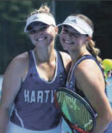 Two female tennis players in Hartwick uniforms